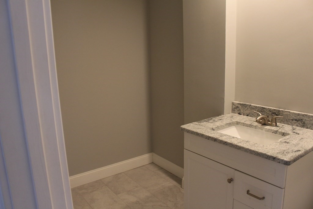 81 Alder Street Waltham, MA 02453 - Photo 14 of 38 a bathroom with a granite countertop sink and a mirror