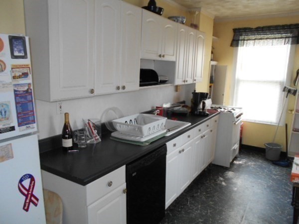 81 Alder Street Waltham, MA 02453 - Photo 19 of 38 a kitchen with a sink stove and cabinets
