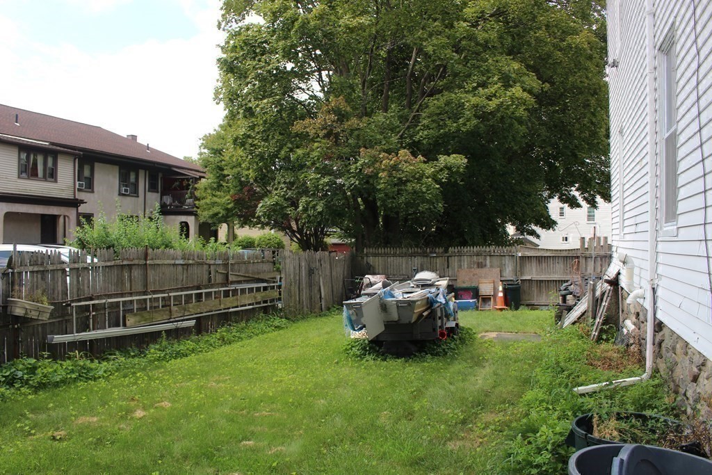 81 Alder Street Waltham, MA 02453 - Photo 29 of 38 a view of backyard with a garden and deck