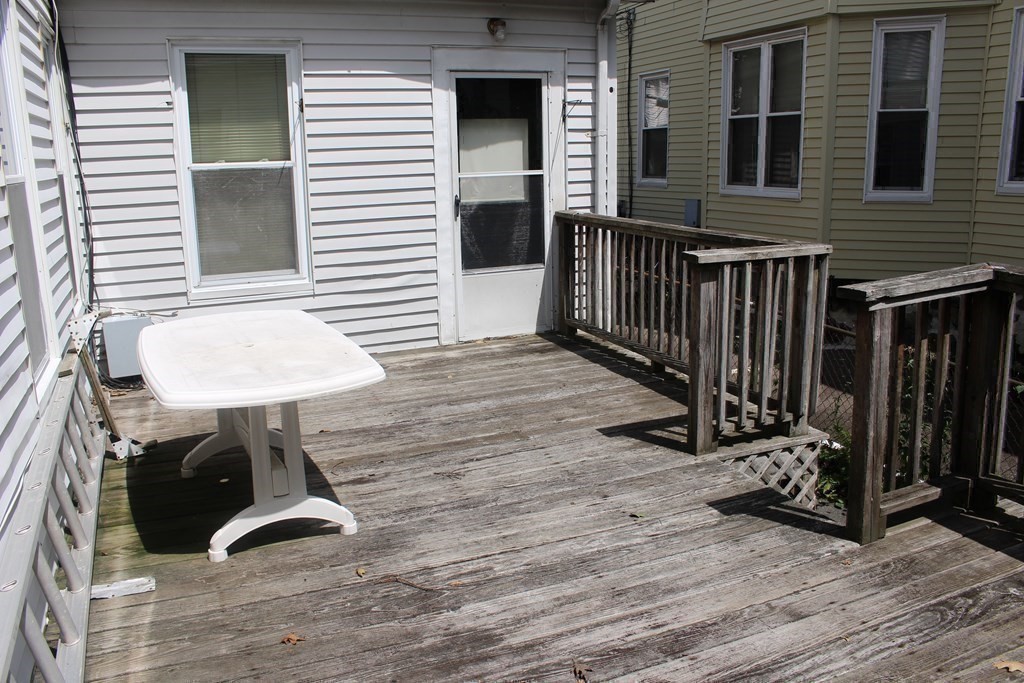 81 Alder Street Waltham, MA 02453 - Photo 31 of 38 a view of a balcony with chair and a potted plant