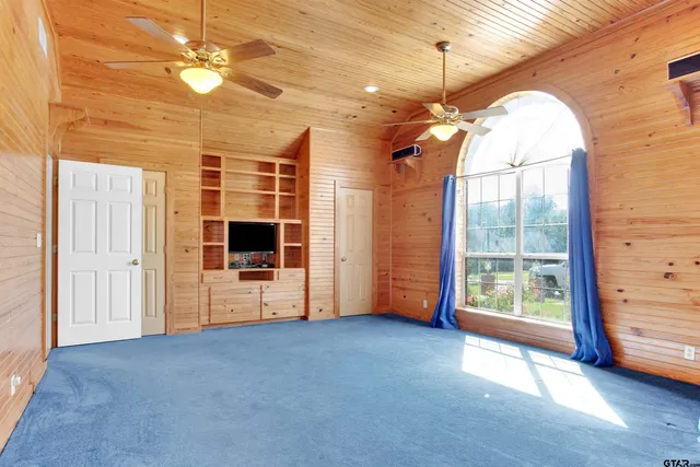 a living room with furniture a rug and a chandelier