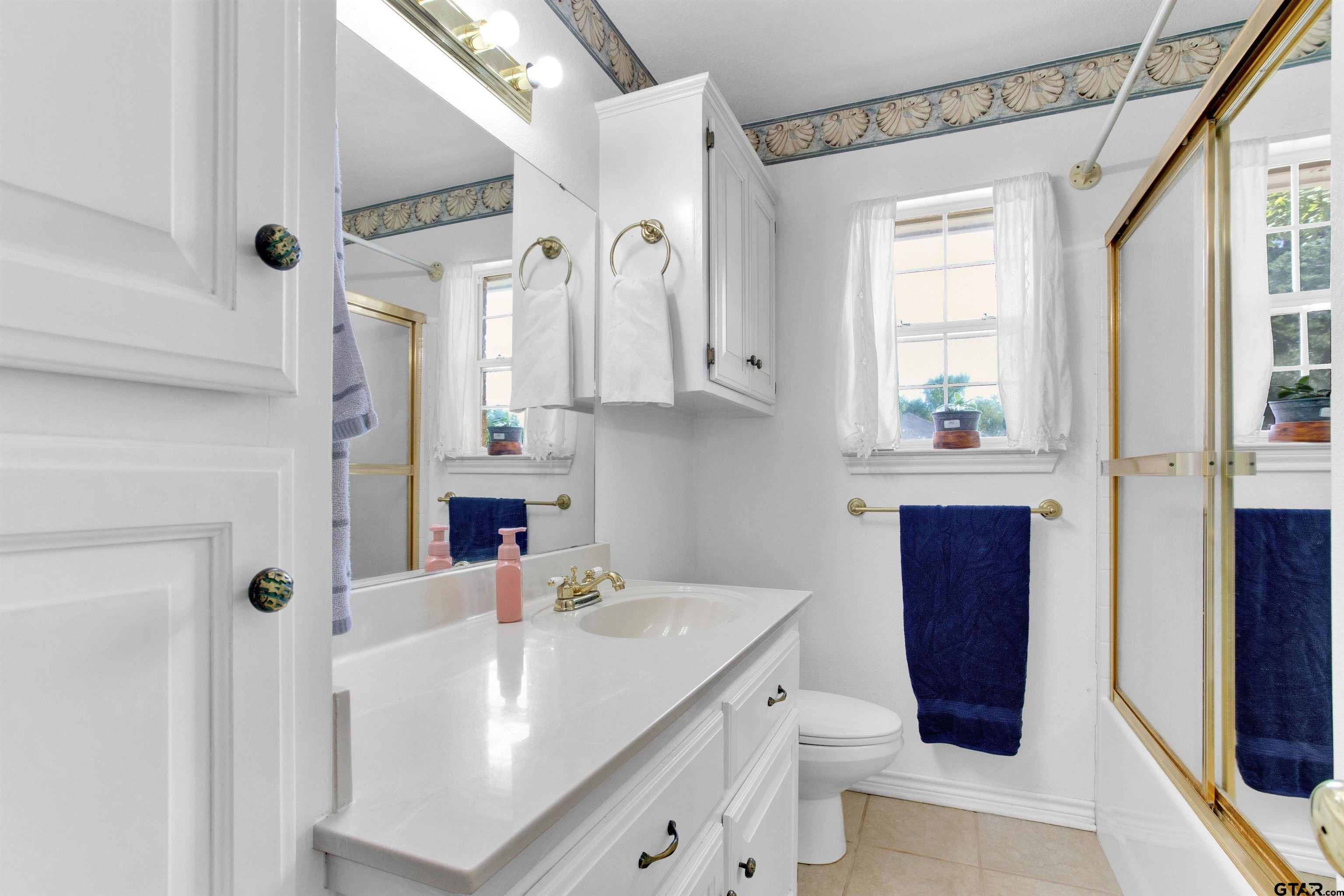149 Pecan Street Frankston, TX 75763 - Photo 15 of 35 a bathroom with a sink a toilet and shower