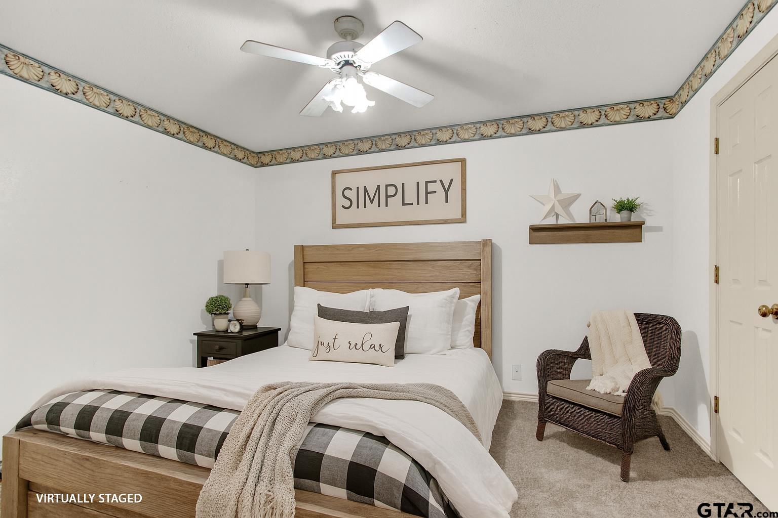 149 Pecan Street Frankston, TX 75763 - Photo 18 of 35 a bedroom with a bed and a chandelier