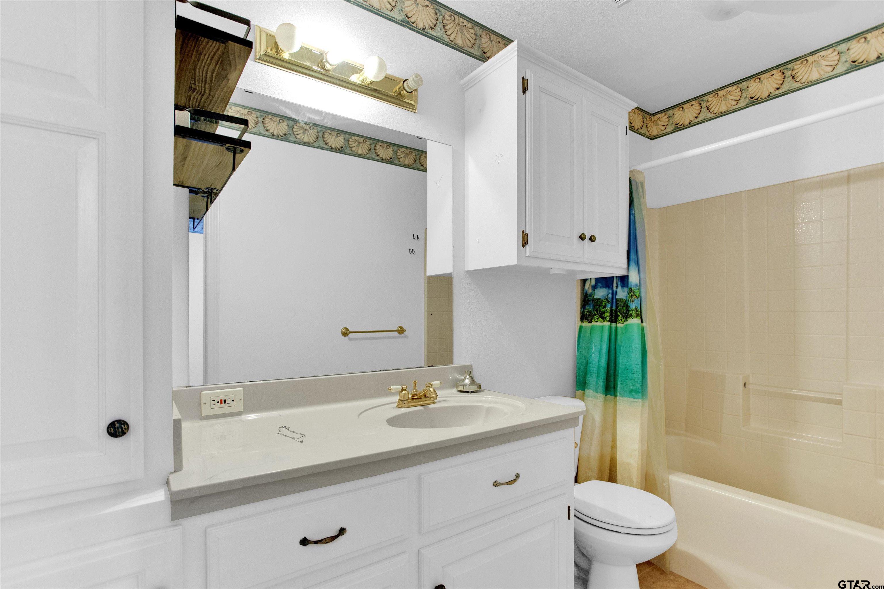 149 Pecan Street Frankston, TX 75763 - Photo 19 of 35 a bathroom with a granite countertop sink a toilet and shower