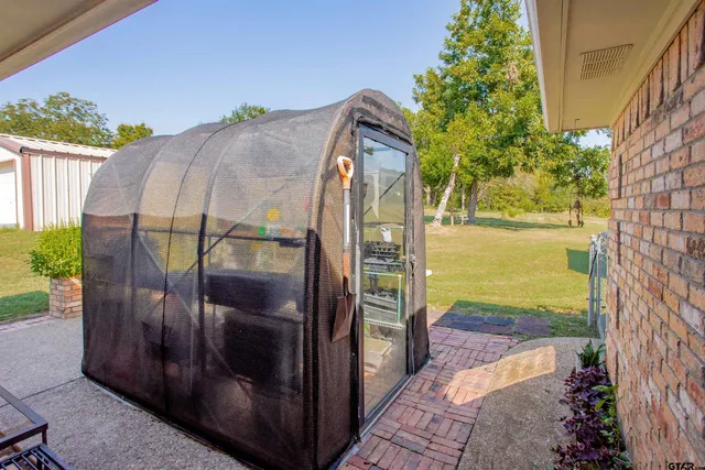 a patio with sofas fire pit table and chairs