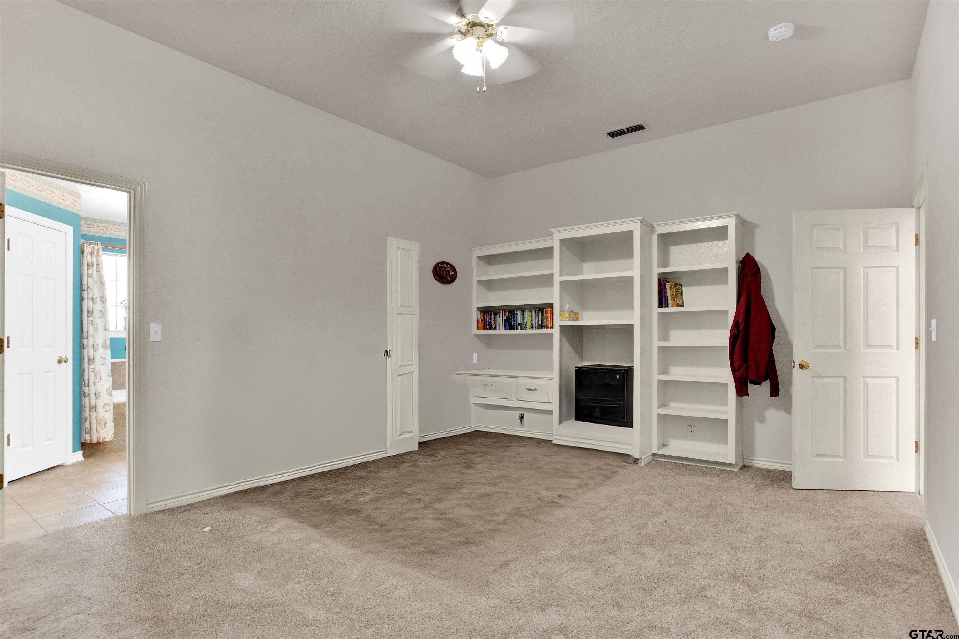 149 Pecan Street Frankston, TX 75763 - Photo 33 of 35 an empty room with a fireplace and cabinet