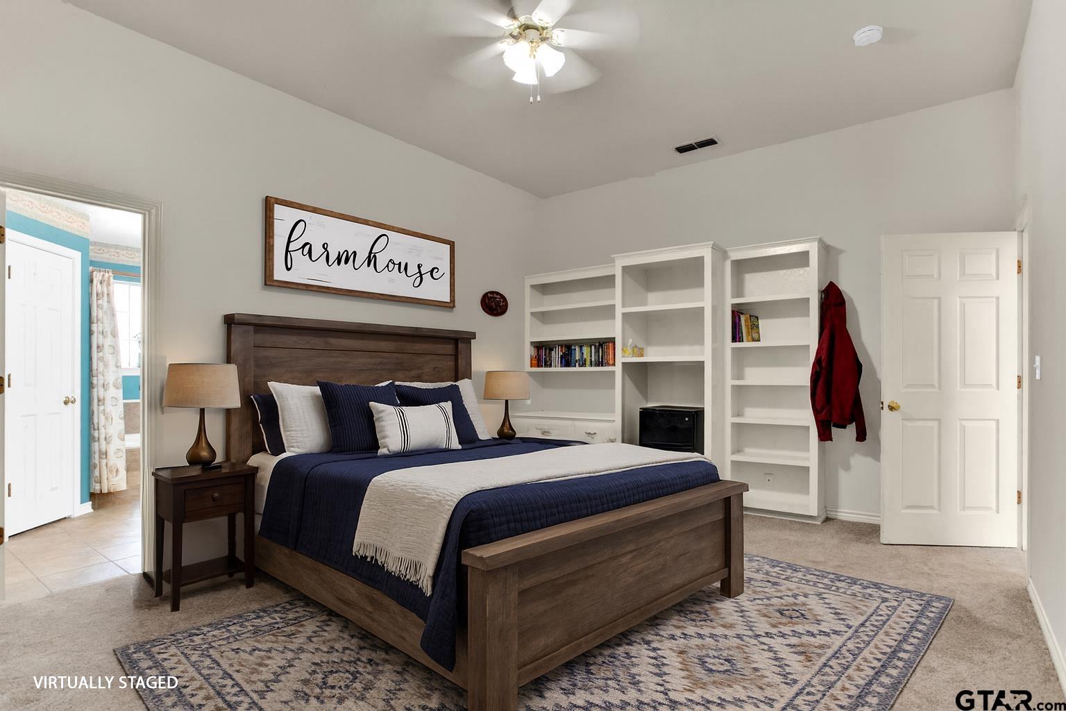 149 Pecan Street Frankston, TX 75763 - Photo 34 of 35 a bedroom with a large bed and a chandelier