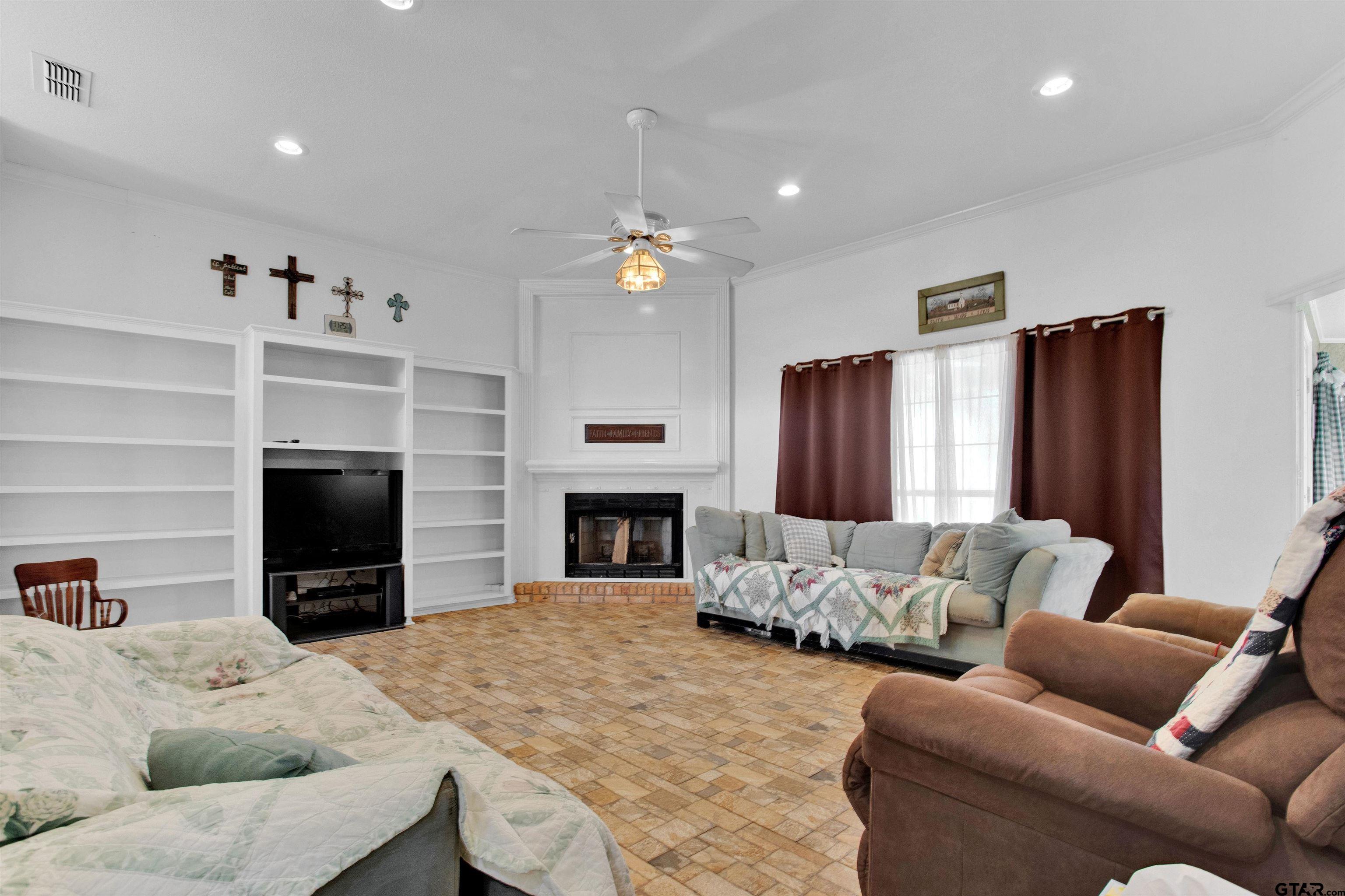 149 Pecan Street Frankston, TX 75763 - Photo 4 of 35 a living room with furniture flat screen tv and a fireplace