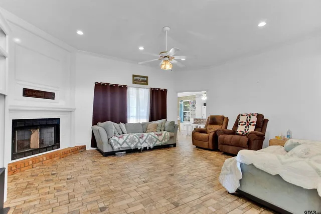 a living room with furniture a fireplace and a chandelier