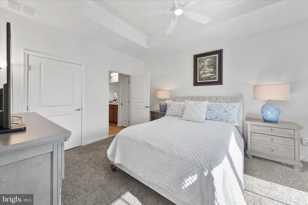 a bedroom with a large bed and a view of living room