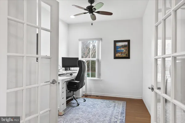 a view of a workspace with furniture and window
