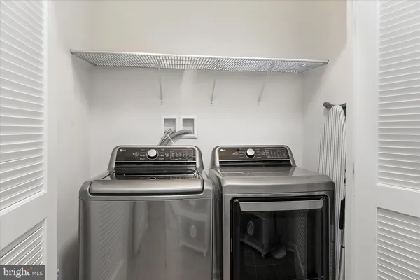 a spacious bedroom with a bed and a flat screen tv