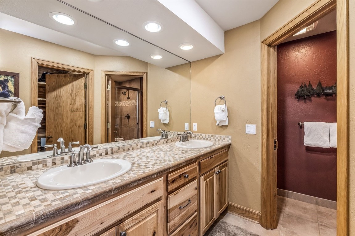 1203 West Keystone Road, Unit 2709 Keystone, CO 80435 - Photo 19 of 48 Full bathroom with a sink, baseboards, double vanity, and a stall shower