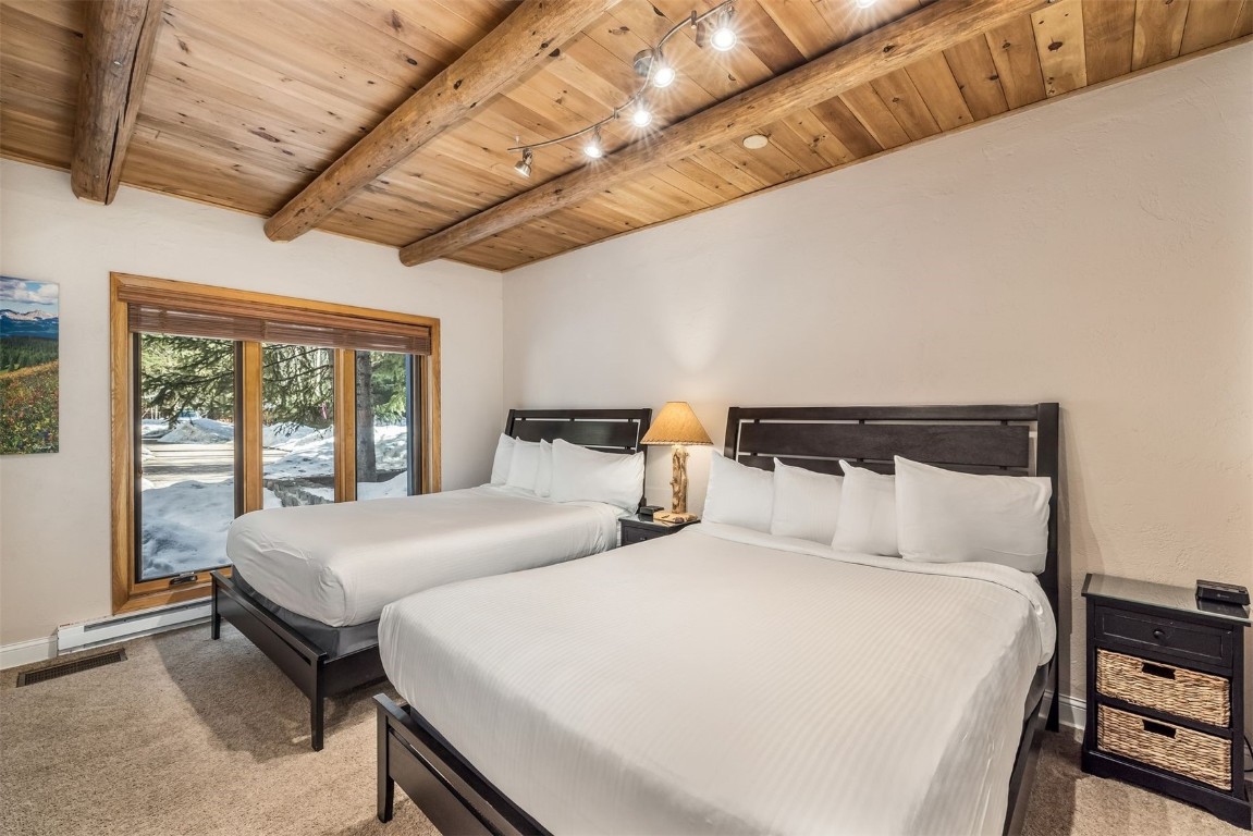 1203 West Keystone Road, Unit 2709 Keystone, CO 80435 - Photo 24 of 48 Bedroom with visible vents, wood ceiling, beamed ceiling, and carpet floors