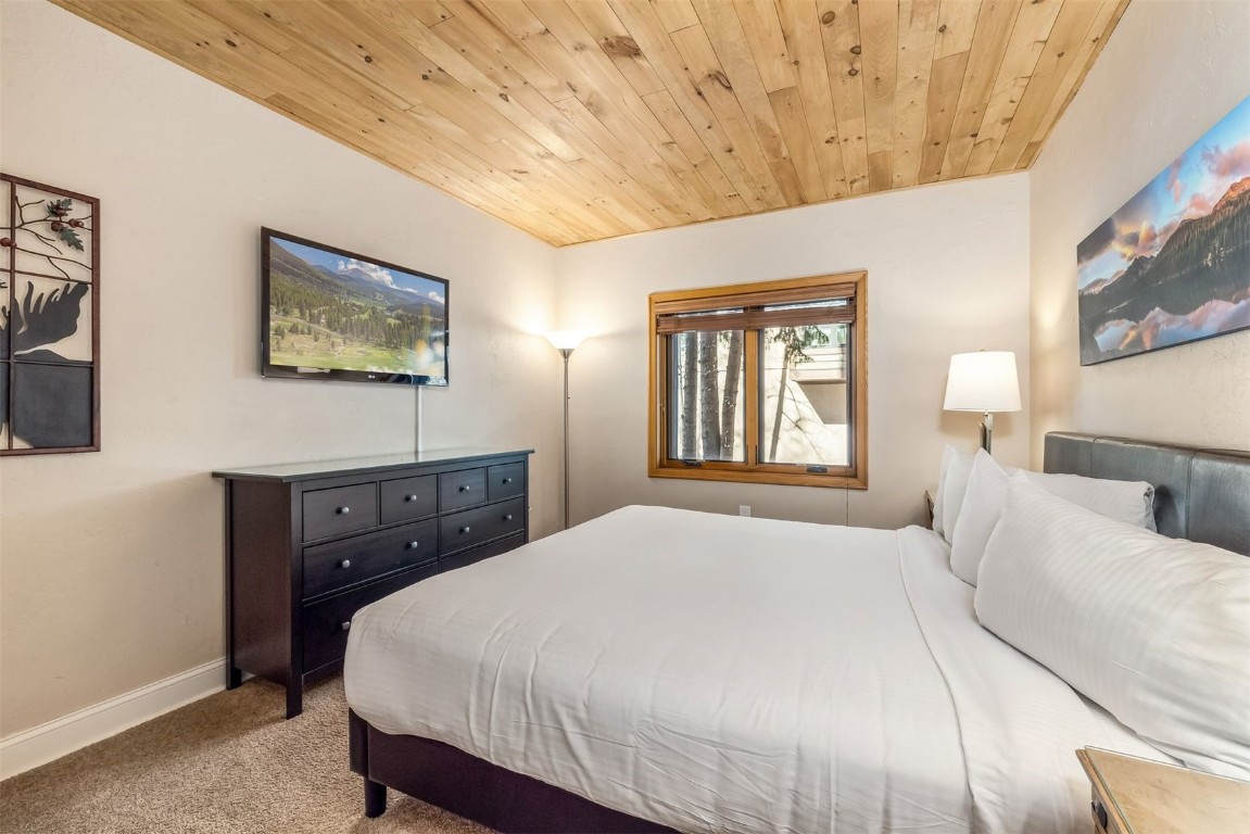 1203 West Keystone Road, Unit 2709 Keystone, CO 80435 - Photo 28 of 48 Bedroom featuring wooden ceiling, baseboards, and carpet floors