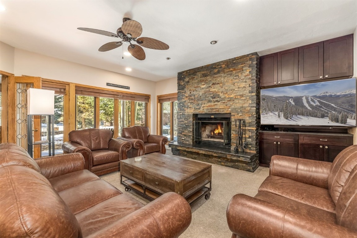 1203 West Keystone Road, Unit 2709 Keystone, CO 80435 - Photo 8 of 48 Living area featuring a ceiling fan, light colored carpet, and a fireplace