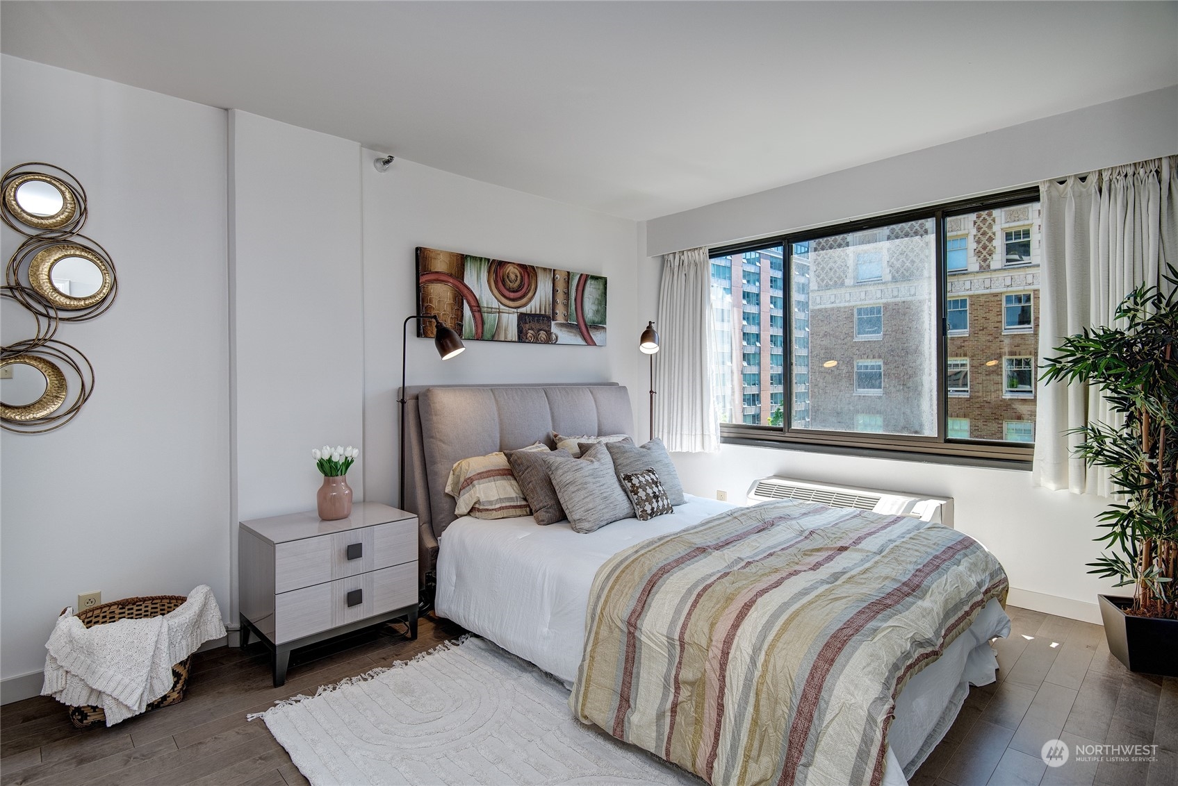 1120 Spring Street, Unit 1004 Seattle, WA 98104 - Photo 9 of 23 a bedroom with a bed and a large window