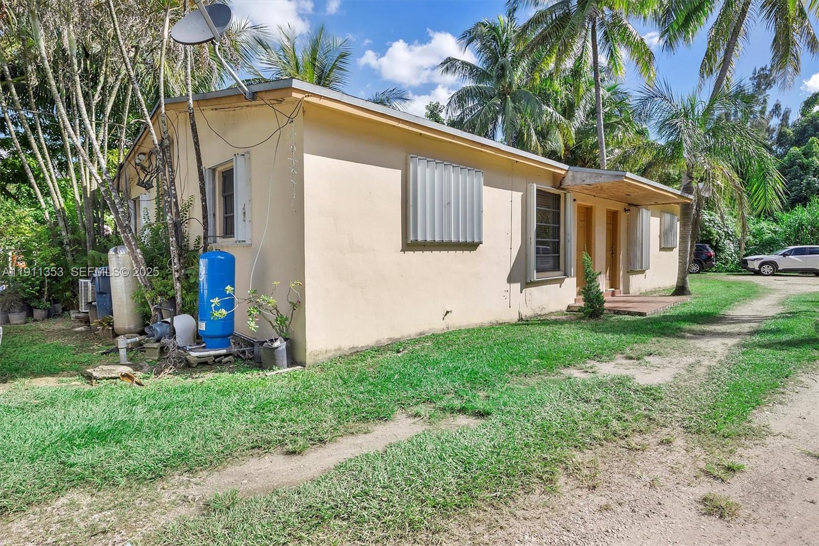 22950 Southwest 156th Avenue Miami, FL 33170 - Photo 2 of 11 a front view of a house with garden