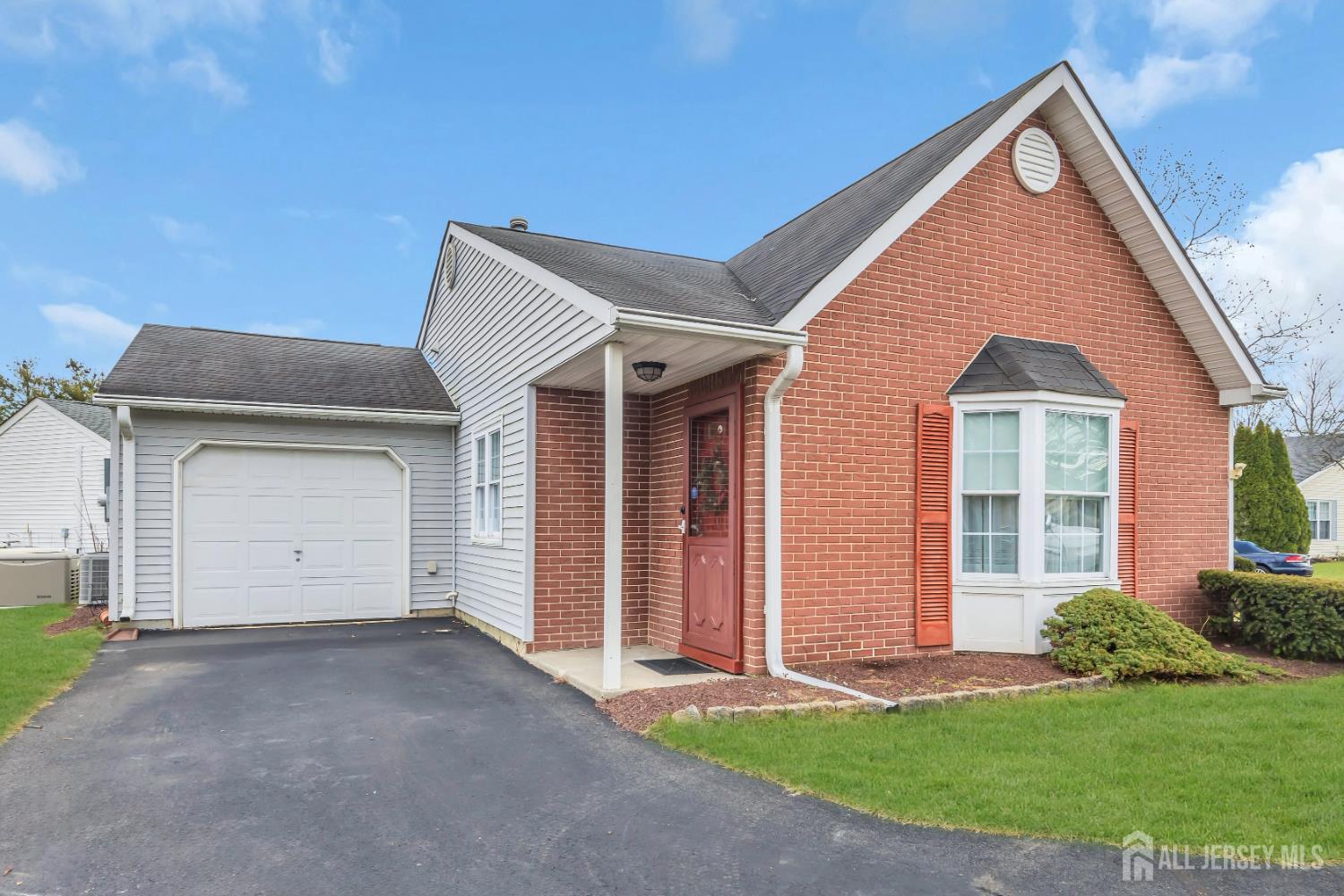 a view of a house with a yard and garage