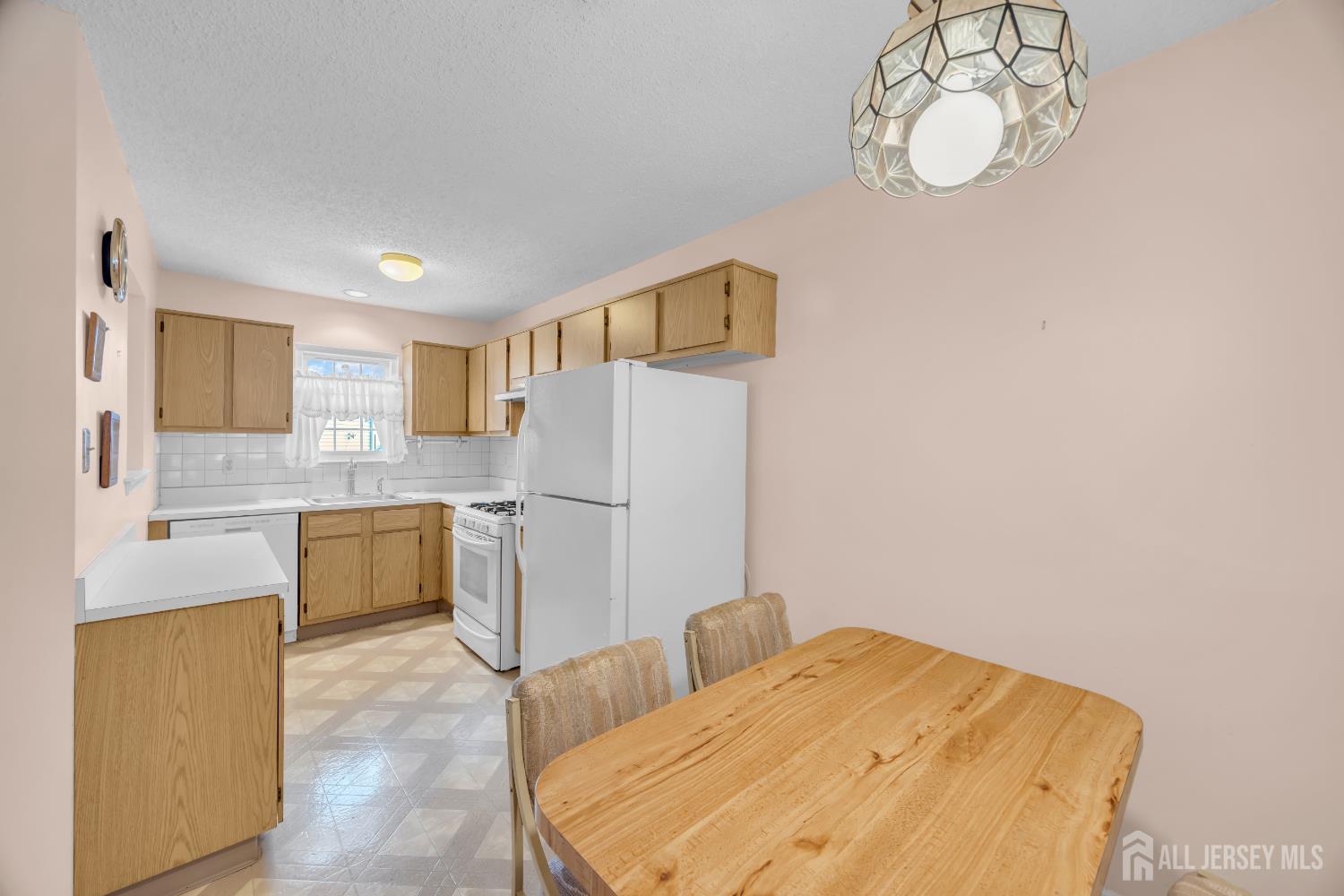 7 Gatley Close Freehold, NJ 07728 - Photo 16 of 36 a kitchen with a refrigerator and cabinets