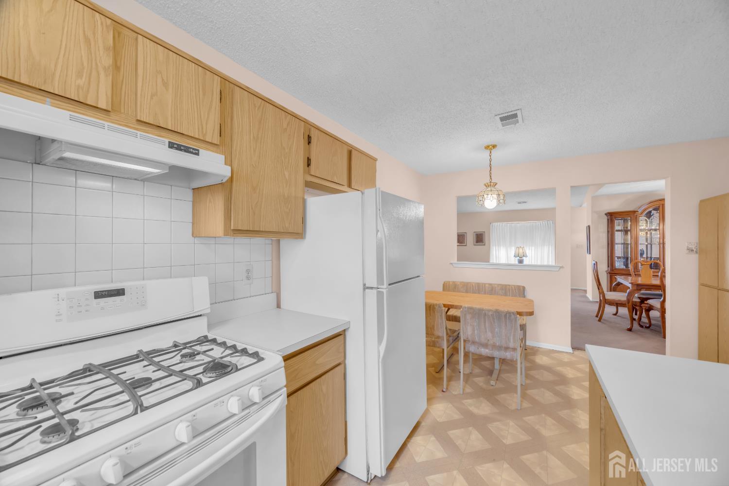 7 Gatley Close Freehold, NJ 07728 - Photo 18 of 36 a kitchen with granite countertop a sink stove and refrigerator