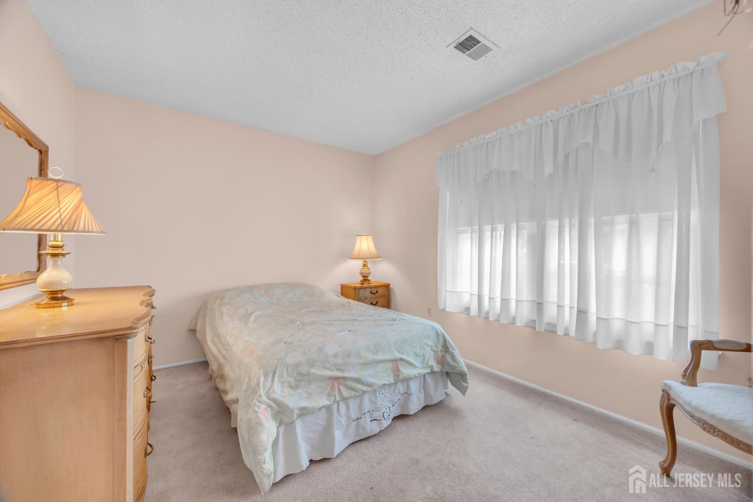 7 Gatley Close Freehold, NJ 07728 - Photo 26 of 36 a bedroom with a bed and a lamp on table