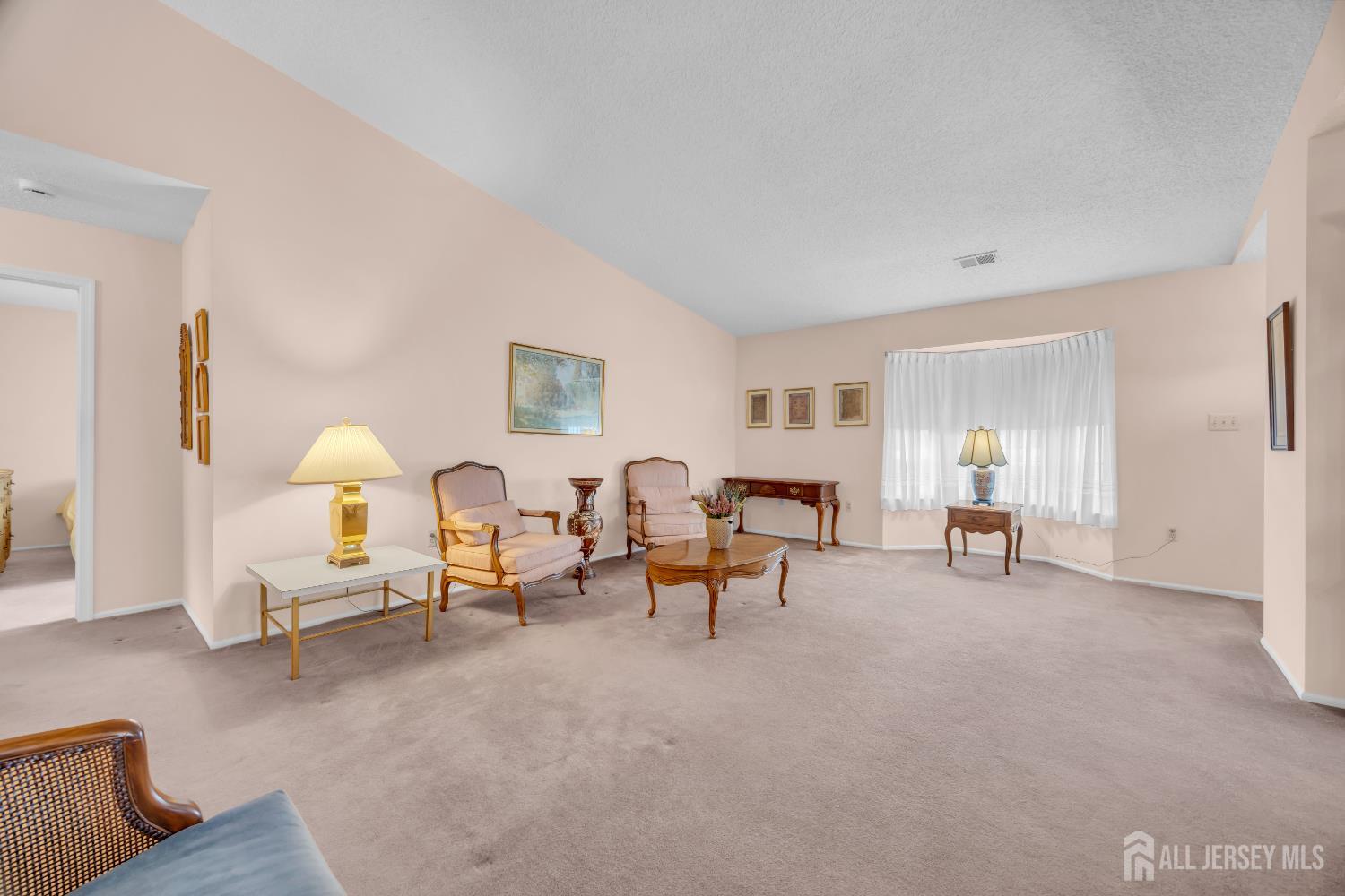 7 Gatley Close Freehold, NJ 07728 - Photo 7 of 36 a living room with furniture and a lamp