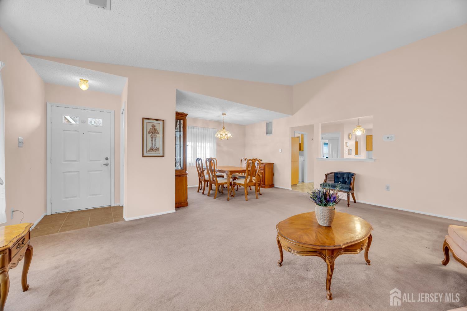 7 Gatley Close Freehold, NJ 07728 - Photo 9 of 36 a living room with furniture and a dining table with wooden floor