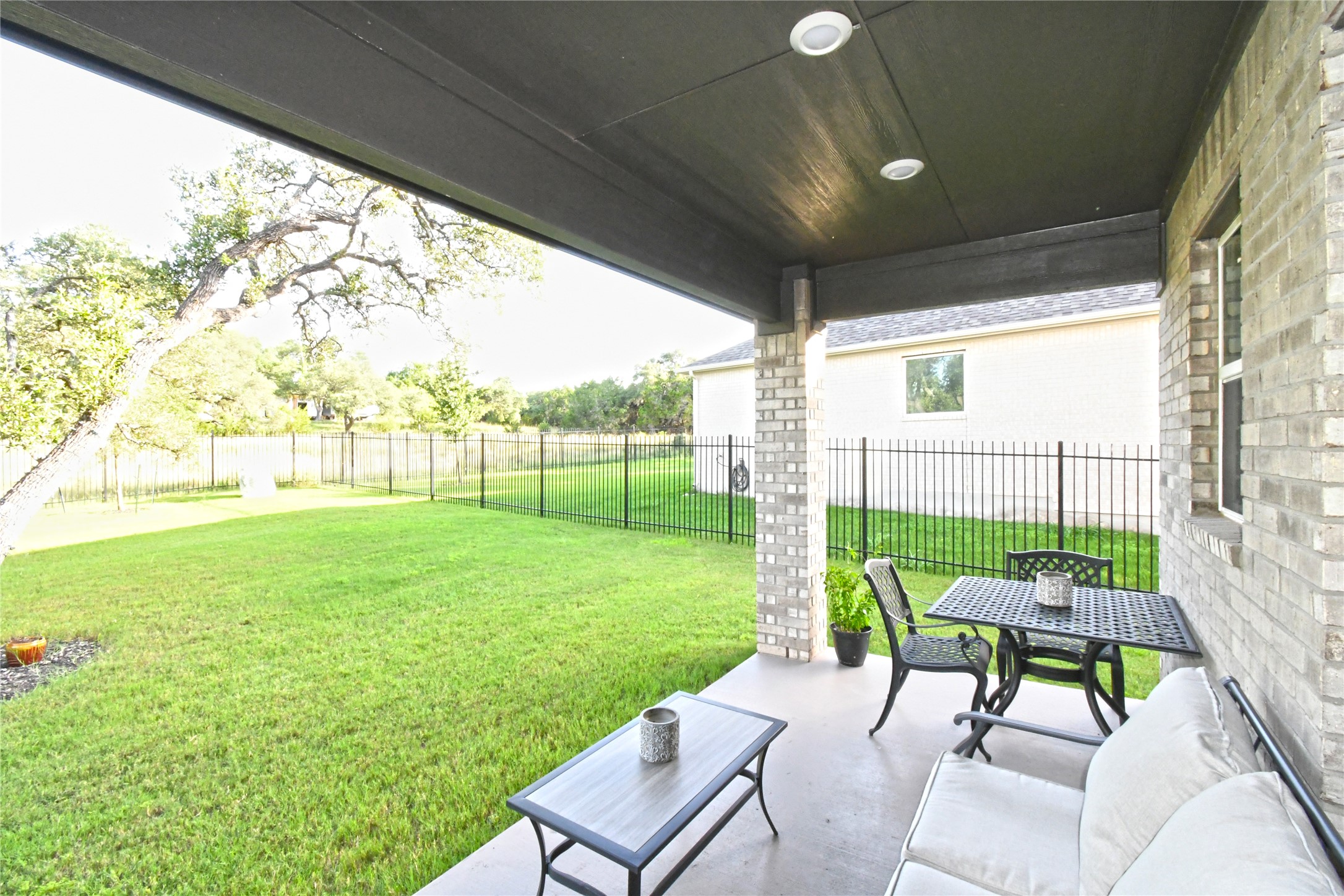 249 Running Bird Road Austin, TX 78737 - Photo 32 of 40 a view of a porch with furniture and a yard