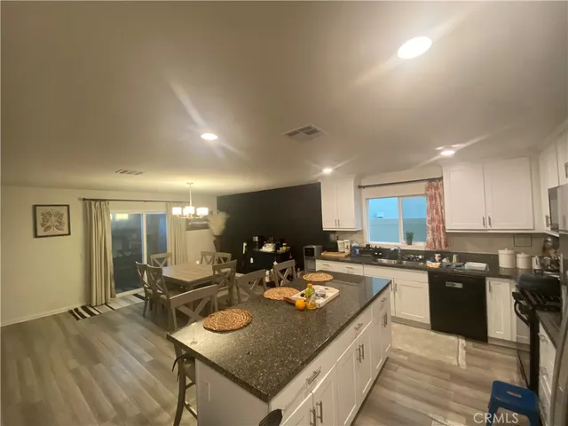 a kitchen with sink refrigerator and cabinets