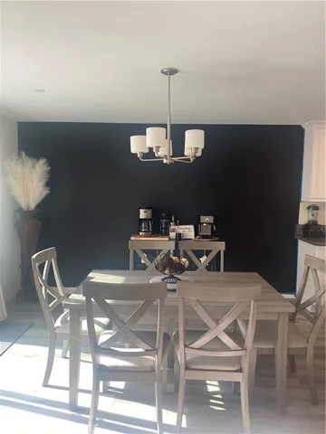 a view of a dining room with furniture and chandelier