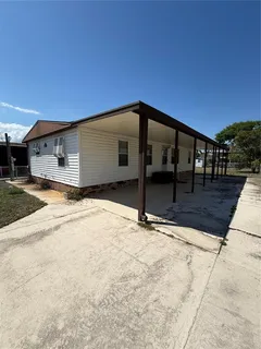 a view of a house with a wooden fence