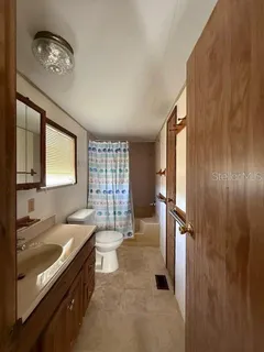 a bathroom with a double vanity sink a toilet and a mirror