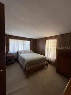 a spacious bedroom with a bed and a window