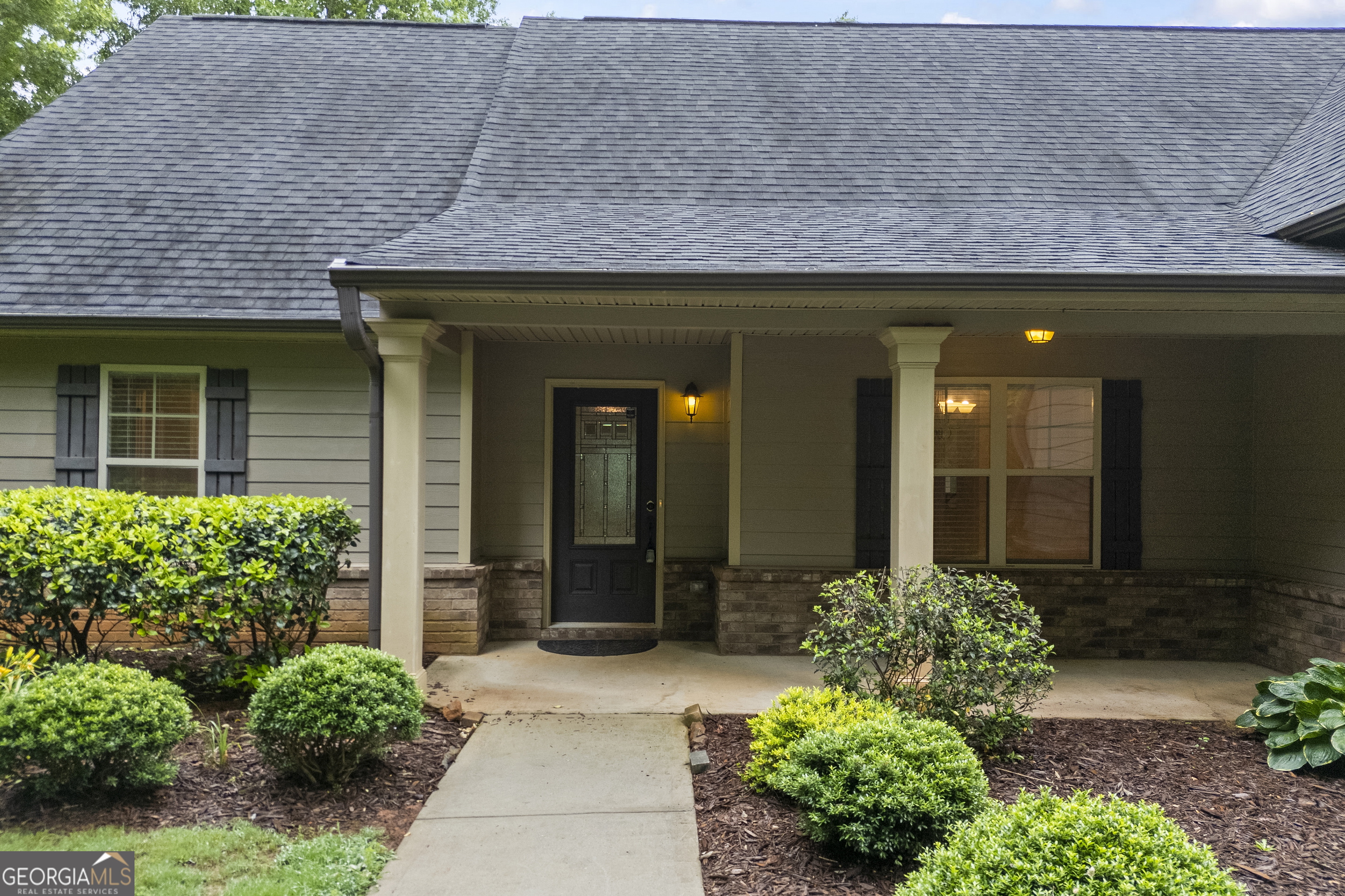 717 Oconee Lane Commerce, GA 30529 - Photo 7 of 57 a front view of a house with a lots of potted plants