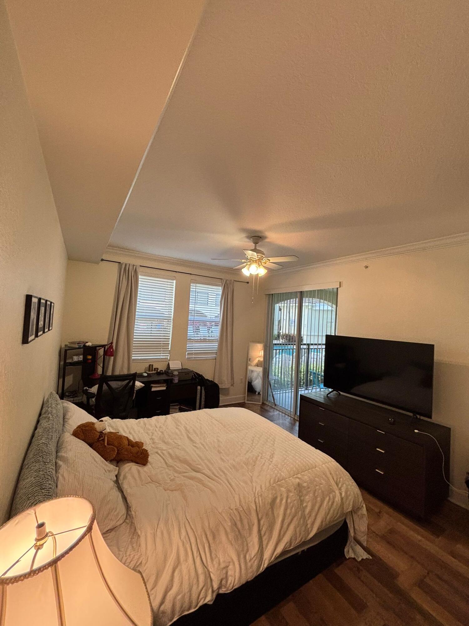 4112 Renaissance Way, Unit 112 Boynton Beach, FL 33426 - Photo 3 of 10 a bedroom with a bed and a television