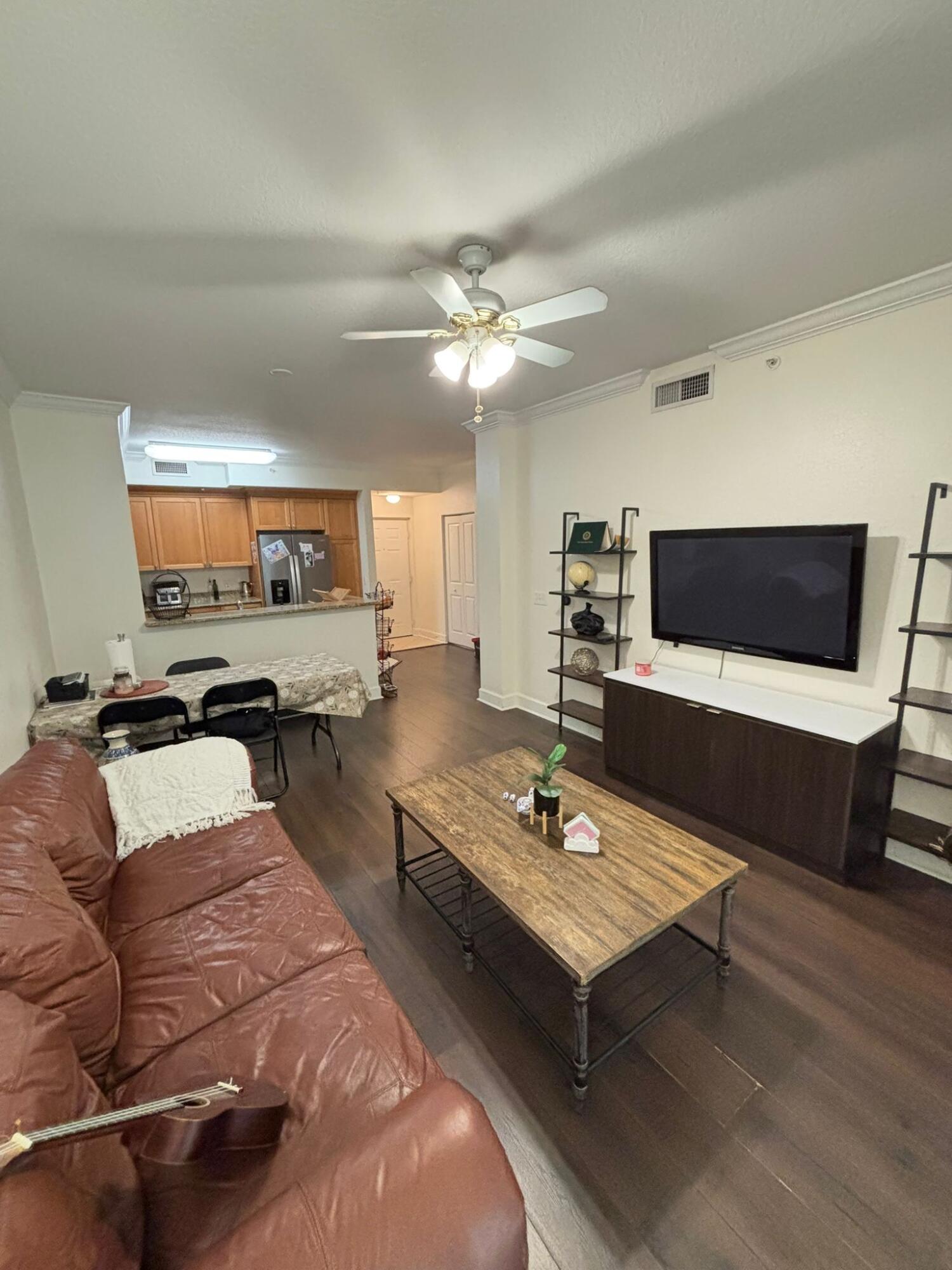 4112 Renaissance Way, Unit 112 Boynton Beach, FL 33426 - Photo 4 of 10 a living room with furniture and a flat screen tv