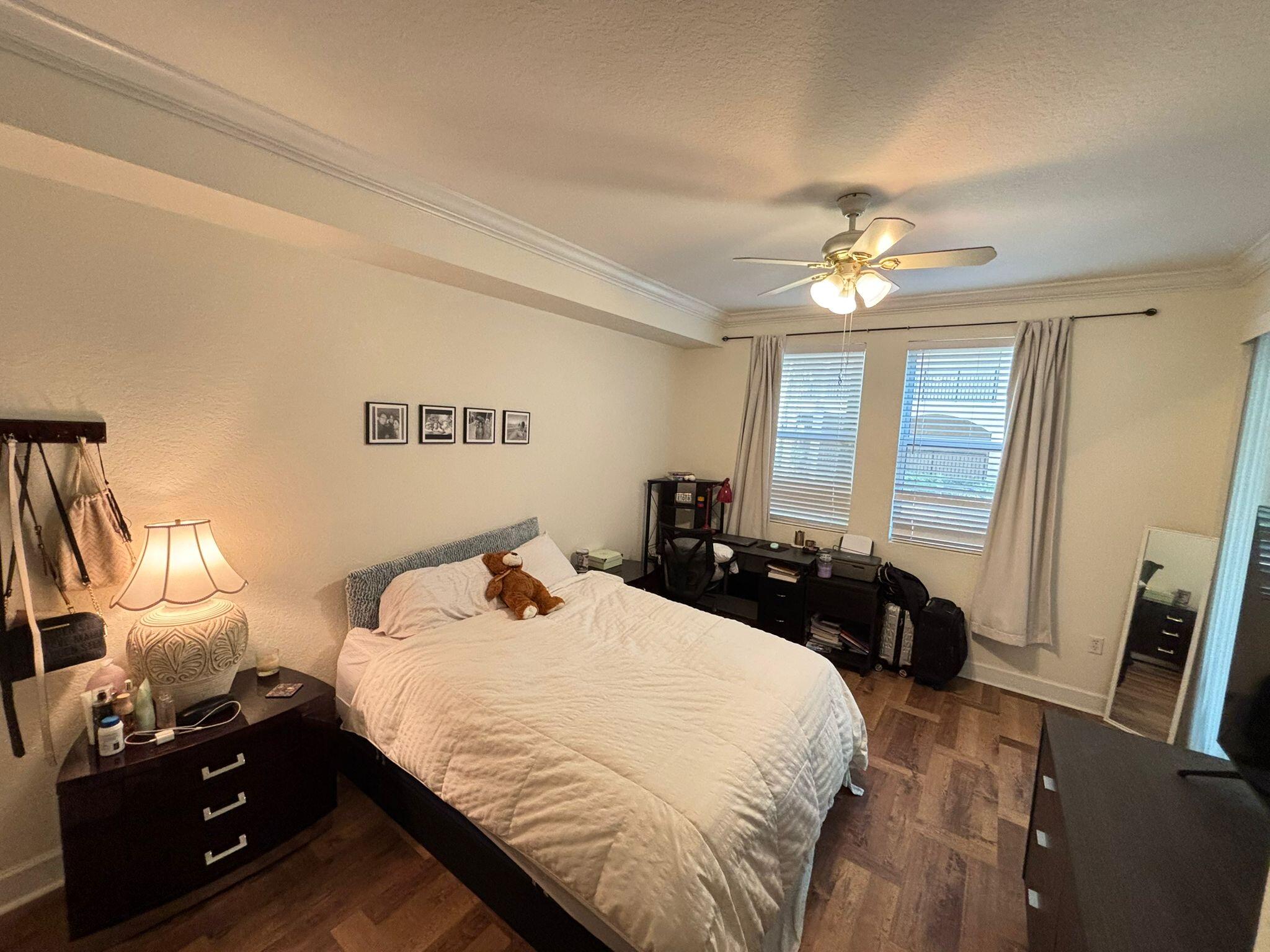 4112 Renaissance Way, Unit 112 Boynton Beach, FL 33426 - Photo 5 of 10 a bedroom with a bed and a chandelier