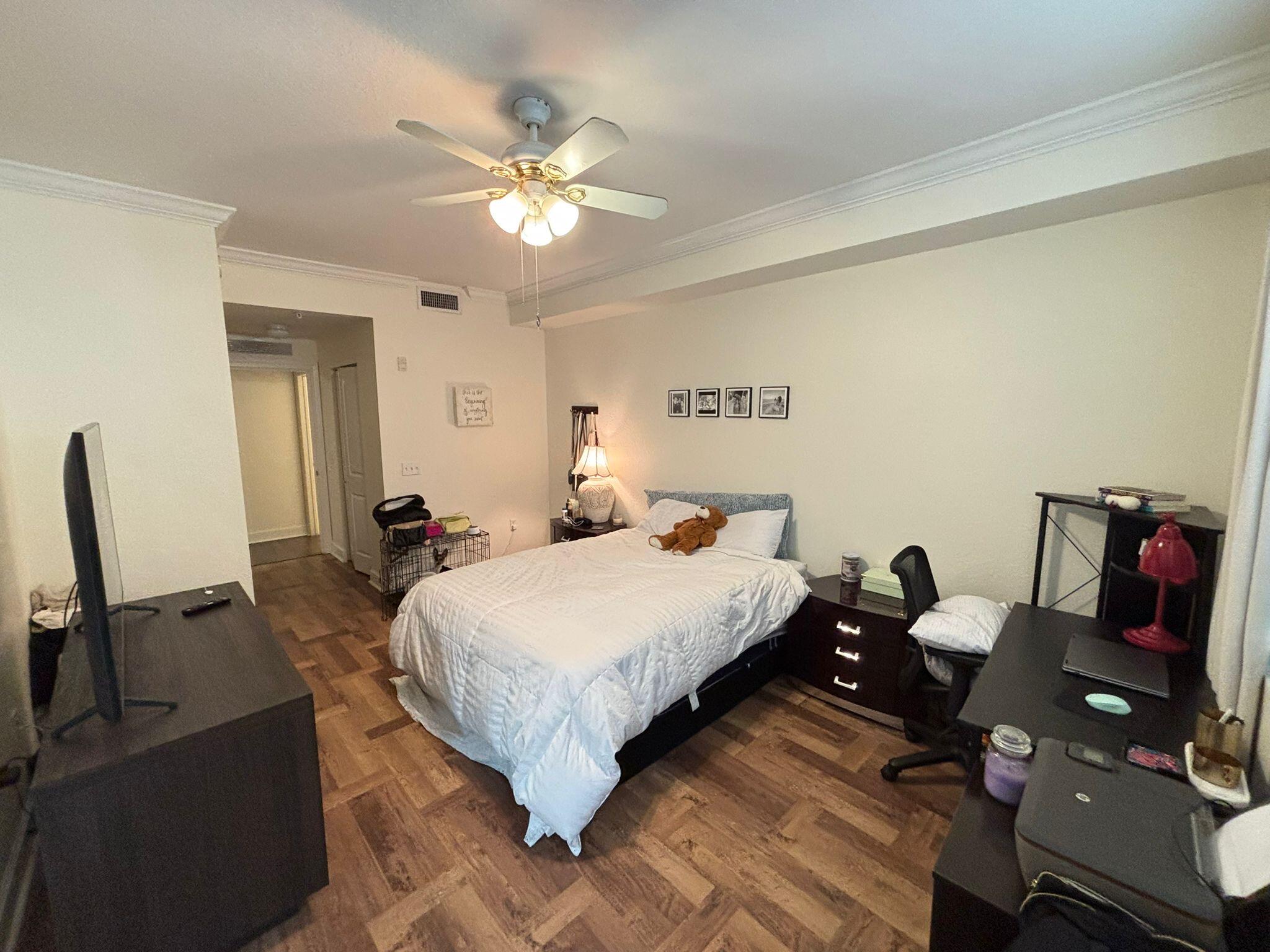 4112 Renaissance Way, Unit 112 Boynton Beach, FL 33426 - Photo 7 of 10 a bedroom with a bed and wooden floor