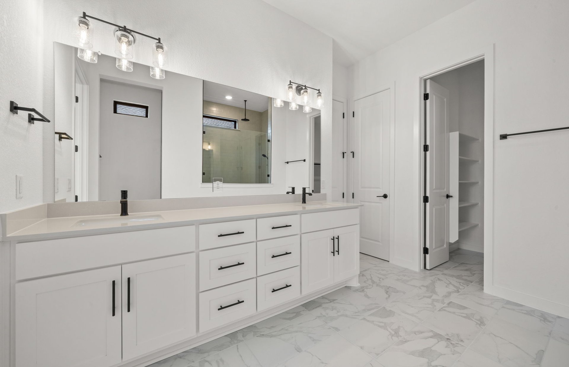 329 Muddy Creek Way Kyle, TX 78640 - Photo 11 of 22 a spacious bathroom with double sink and a mirror