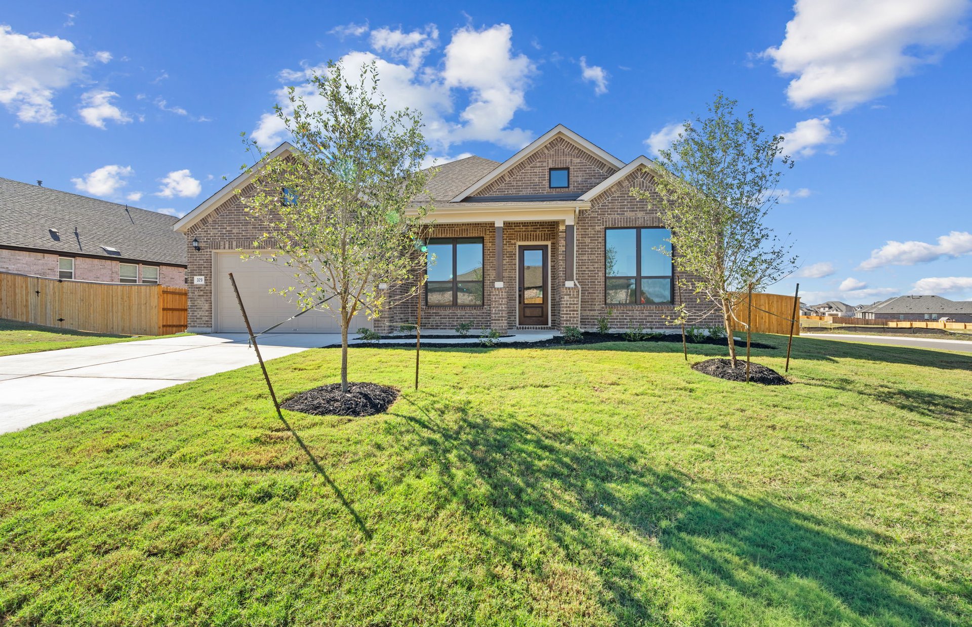 329 Muddy Creek Way Kyle, TX 78640 - Photo 2 of 22 a front view of a house with a yard