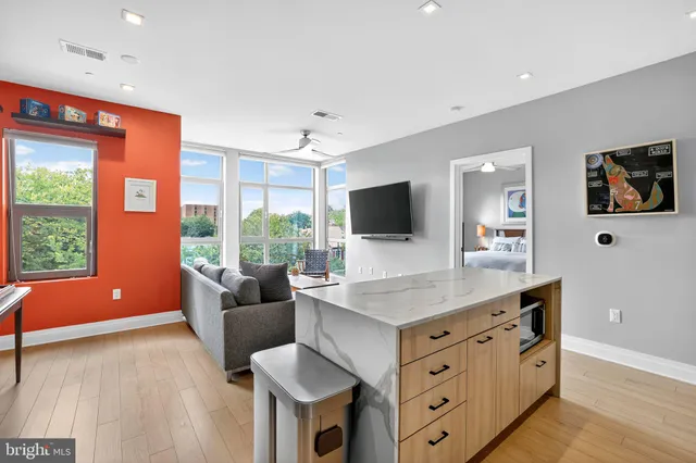 a kitchen with stainless steel appliances granite countertop a sink and a microwave