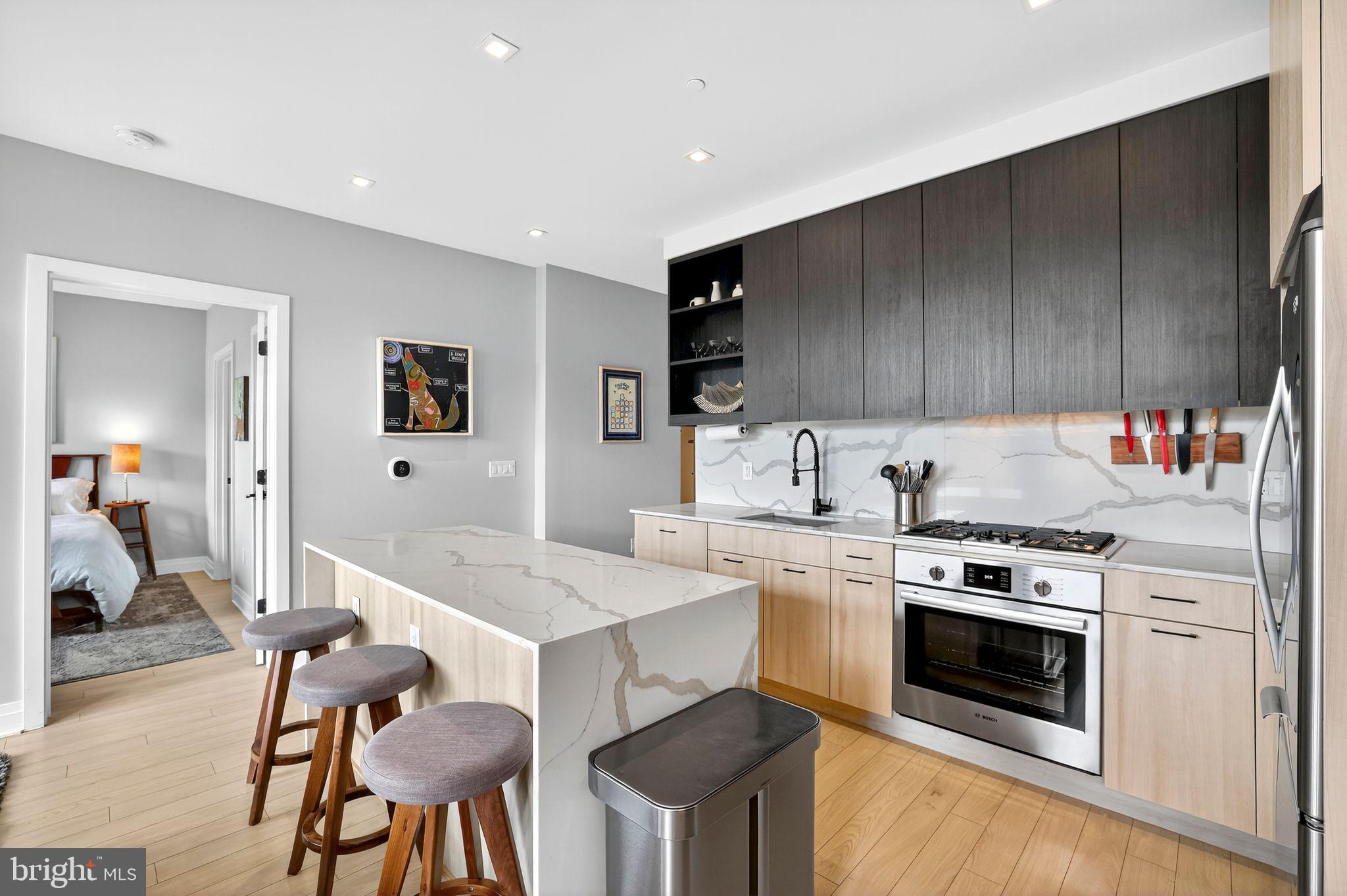 900 11th Street Southeast, Unit 308 Washington, DC 20003 - Photo 9 of 36 a kitchen with stainless steel appliances a stove a sink cabinets and a refrigerator