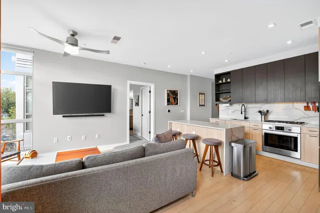 a kitchen with stainless steel appliances kitchen island granite countertop a refrigerator and a stove top oven