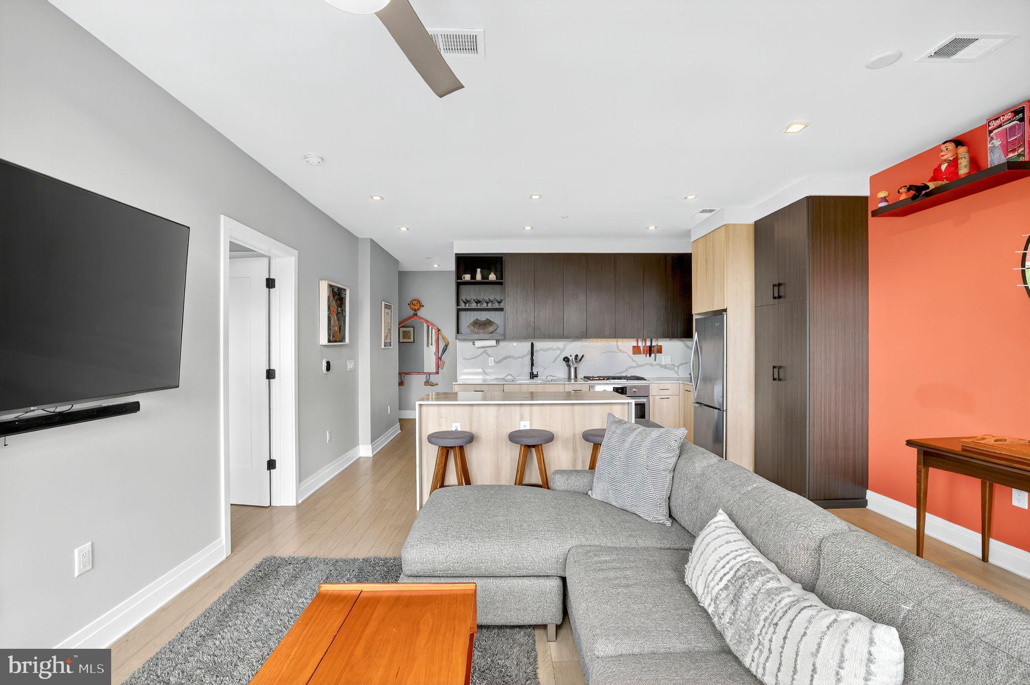 900 11th Street Southeast, Unit 308 Washington, DC 20003 - Photo 11 of 36 a view of a living room a dining room wooden floor and a flat screen tv