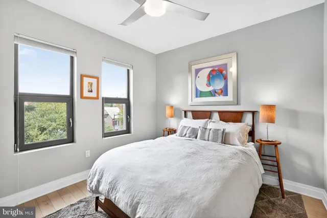 a living room with stainless steel appliances furniture and a flat screen tv