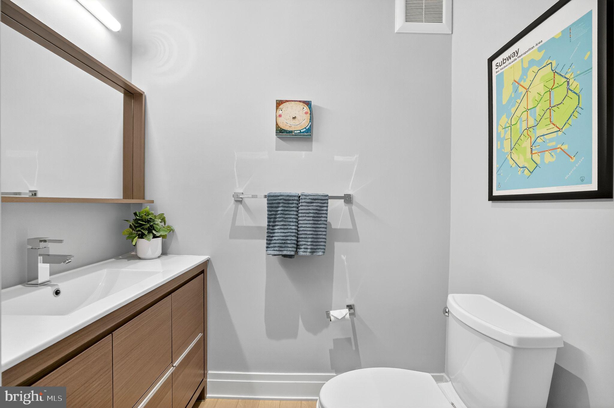 900 11th Street Southeast, Unit 308 Washington, DC 20003 - Photo 20 of 36 a bathroom with a sink toilet and mirror