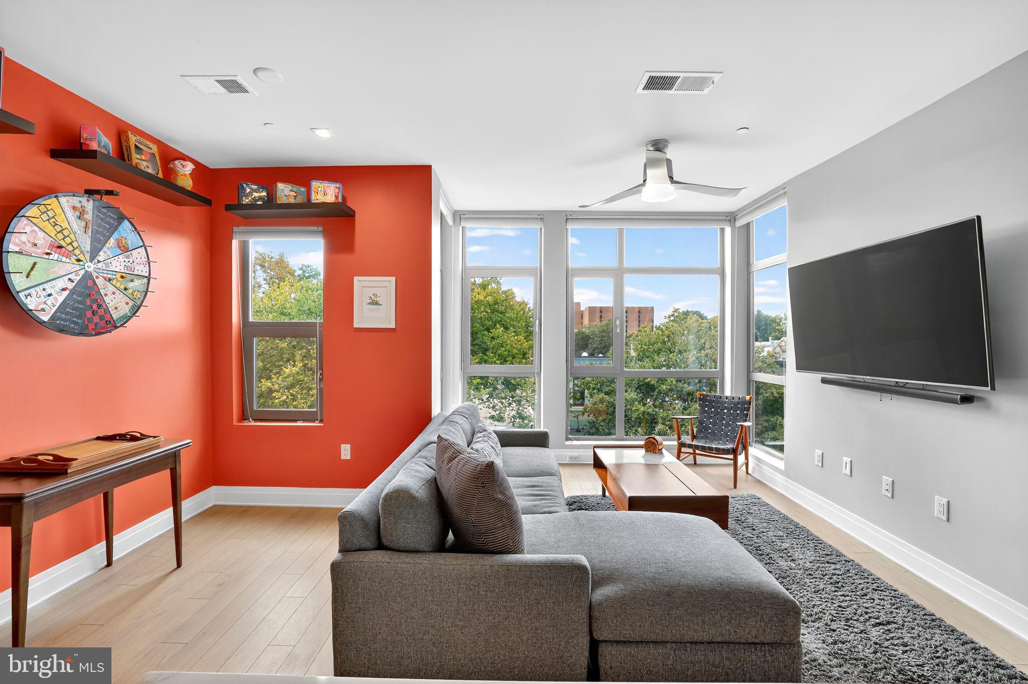 900 11th Street Southeast, Unit 308 Washington, DC 20003 - Photo 3 of 36 a living room with furniture a flat screen tv and a large window