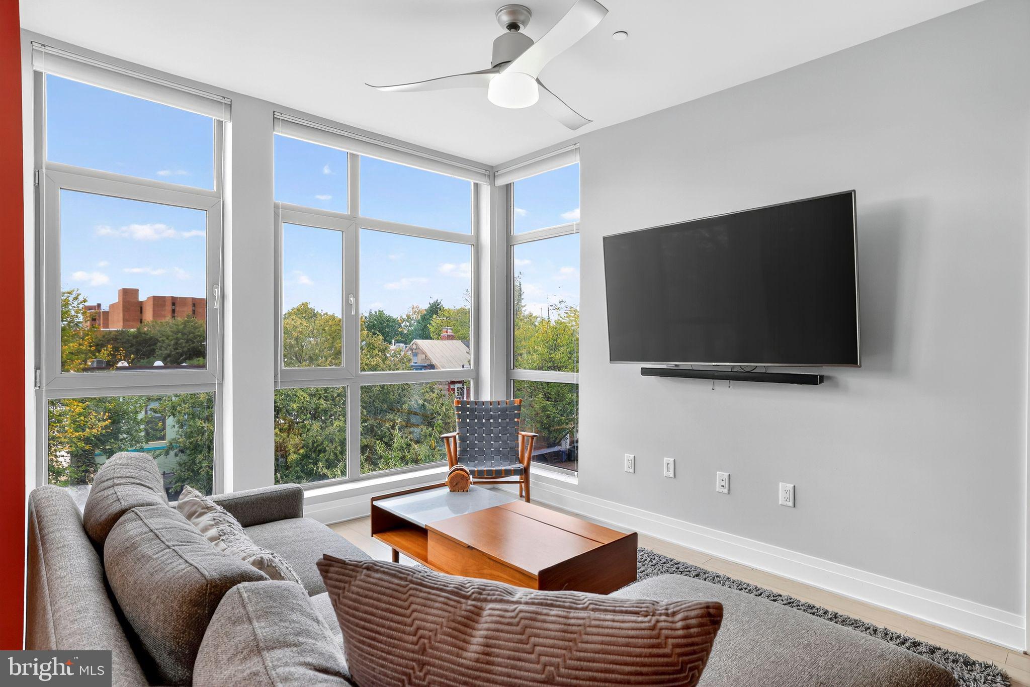 900 11th Street Southeast, Unit 308 Washington, DC 20003 - Photo 5 of 36 a living room with furniture and a flat screen tv