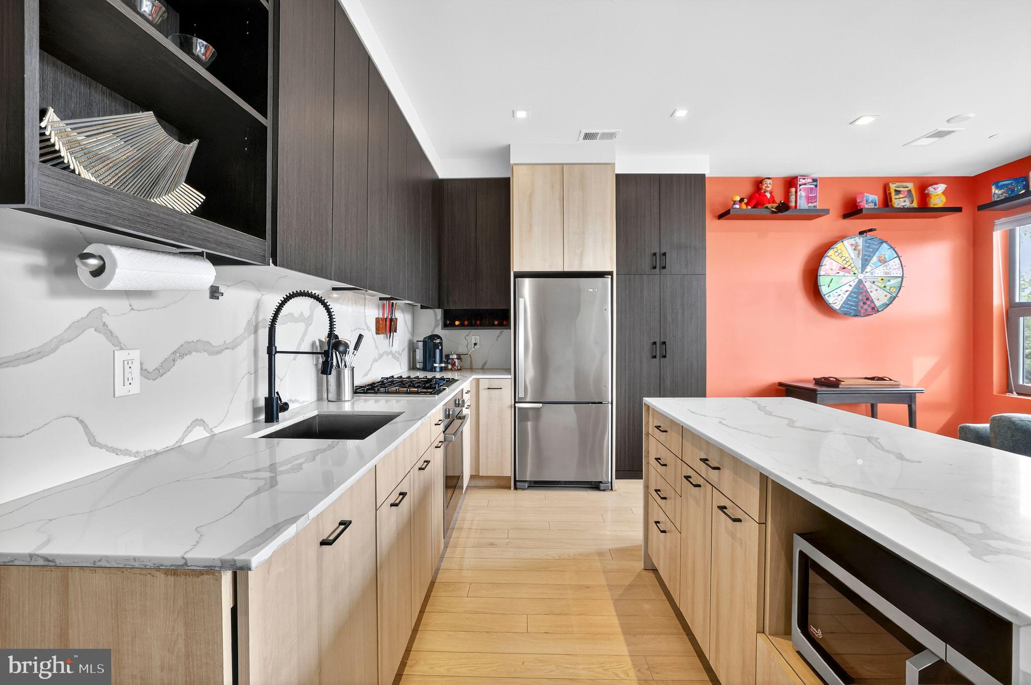 900 11th Street Southeast, Unit 308 Washington, DC 20003 - Photo 6 of 36 a kitchen with a sink a stove and a refrigerator